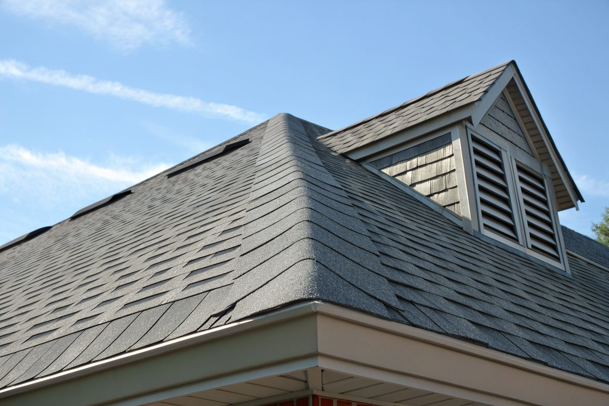 A gray shingle roof with a ridge vent along the peak and a vented gable